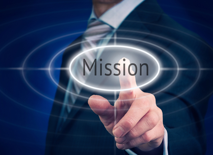 Businessman pressing a Mission concept button.